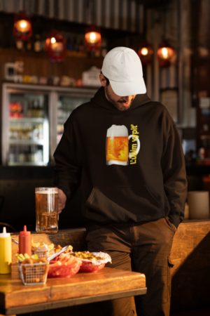 dad hat and gildan hoodie mockup featuring a bearded man holding a beer glass in a sports bar m38088 1