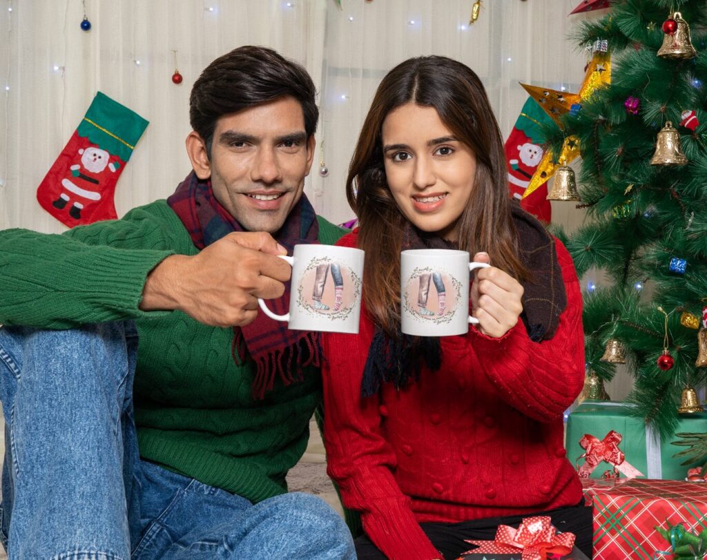mockup of a happy couple holding coffee mugs in a christmas reunion m30636